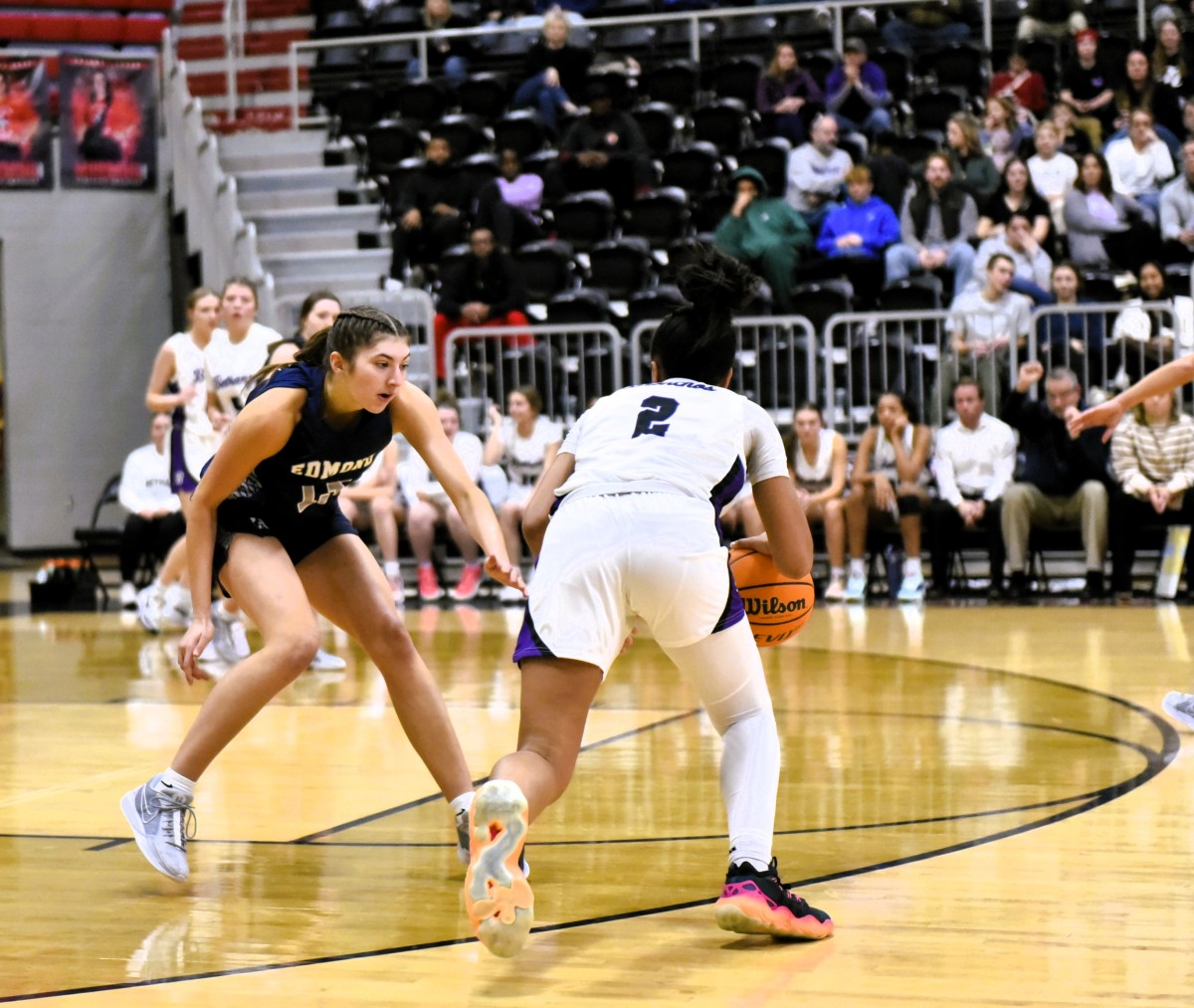 Edmond North senior Allison Heathcock (left) guards an opposing player during a recent game. Heathcock has signed to play next season at Creighton University.